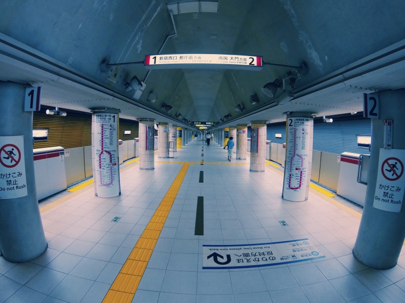 parking garage, signs, floor, train, architecture, mode of transportation, public transportation, script, maps, pillars, station, sign, empty, arrows, subway station