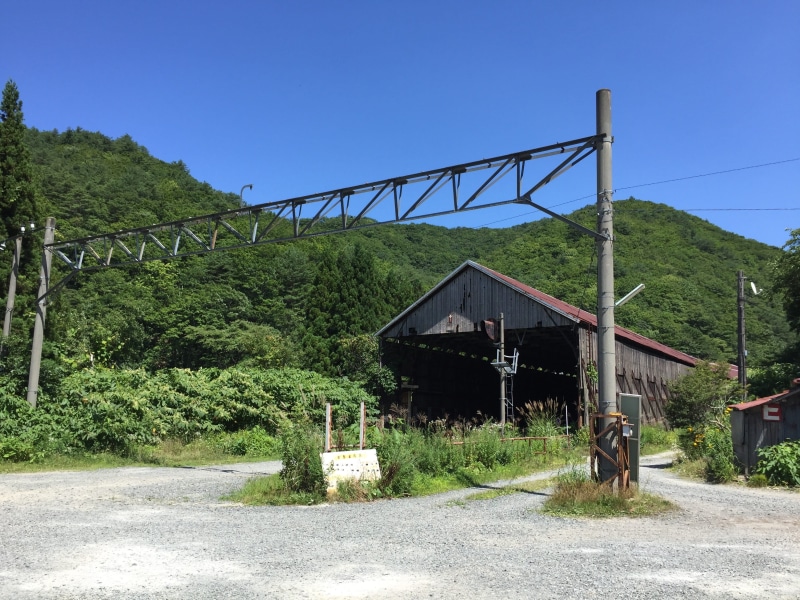 blue, building exterior, bridge, train station, mountain, tree, architecture, track, train, landscape, sky, built structure, tsubasa, day, no people, road