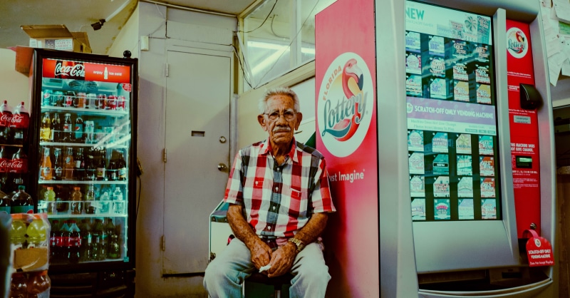 sitting, retail, machine, refrigerator, males, shop, one person, small business, casual clothing, vending machine, looking at camera, interior design, 5K