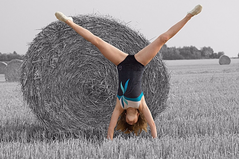 adult, vitality, hay, women, pretty, blond, flexibility, outdoors, young, arms raised, nature, leisure activity, full length, child, exercising, one person