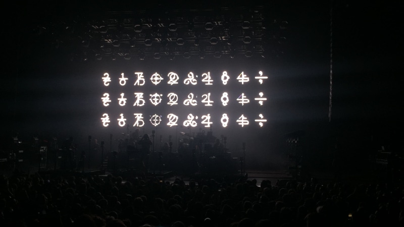 building, indoors, communication, text, travel destinations, dark, Bon Iver, travel, crowd, group of people, night, script, lighting equipment, religion