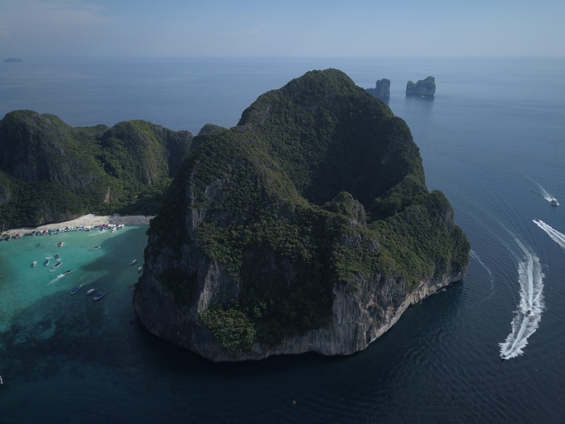 rocky coastline, maya beach, vacations, day, sky, tourism, bay, boat, land, scenics - nature, asia, drone, solid, island, rock - object, phi phi, tranquility