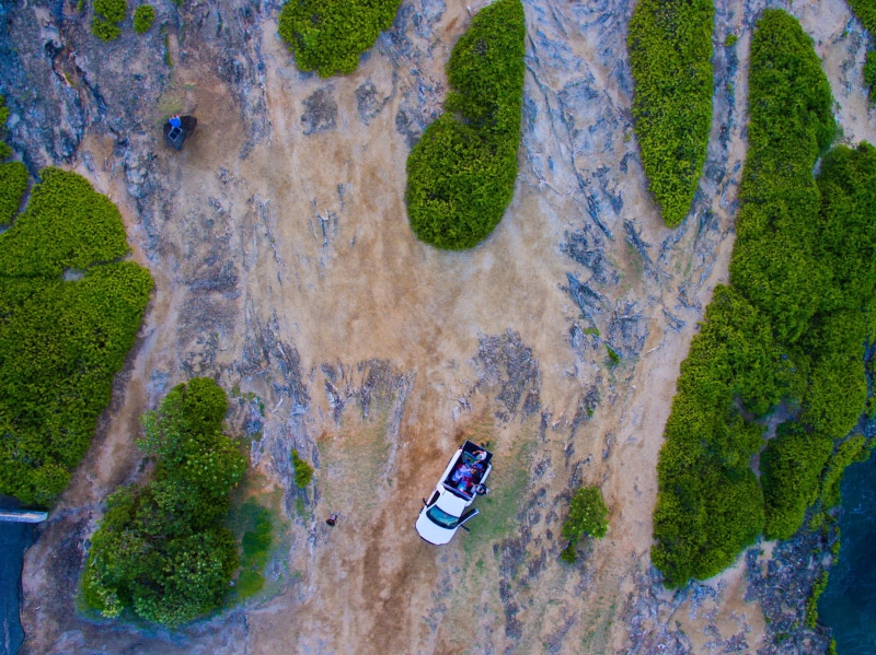 s, outdoors, beach, high angle view, classic, train, environment, land, green color, non-urban scene, view, drone view, photograph, transportation, day