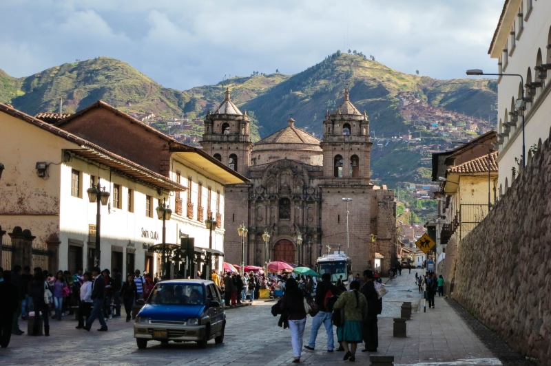 pedestrians, hills, group of people, crowd, land vehicle, Cusco, sky, adult, city, car, mountains, buildings, peru, mode of transportation, near, transportation