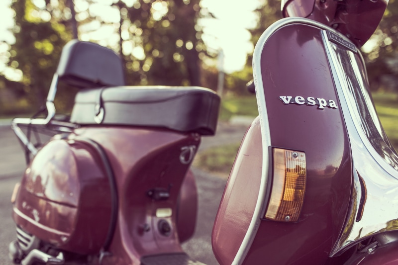 number, motor scooter, text, motor, ride, motorcycle, land, vehicle, three objects, transportation, old, maroon, aprilia, red, vintage, plant, piaggio