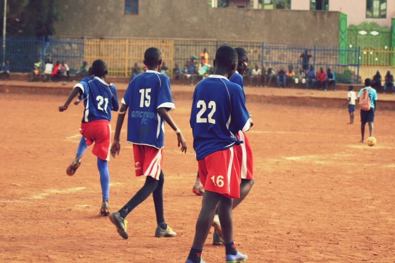 lifestyles, team, competition, child, soccer, childhood, women, real people, rwanda, africa, incidental people, football, focus on foreground, number, kigali