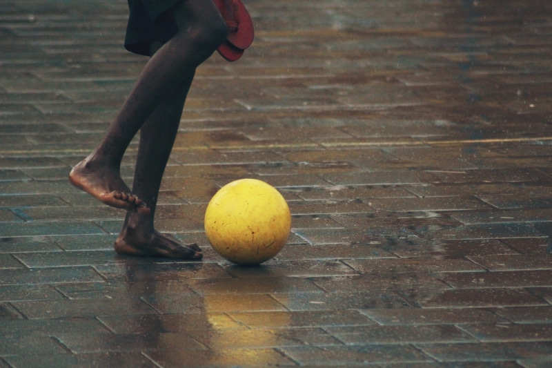standing, brick, african american, rain, soccer, footpath, 4K, outdoors, male, lifestyles, paving stone, floor, front, sport, day, playing, ball, football