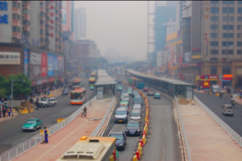 high angle view, city life, on the move, several, tilt shift, outdoors, transportation, built structure, color, traffic, city street, land vehicle, vehicles