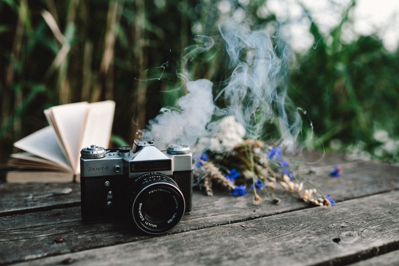 photography themes, vintage, selective focus, book, old, fun, smoke, outdoor, single object, colorful smoke, plant, photographic equipment, focus on foreground
