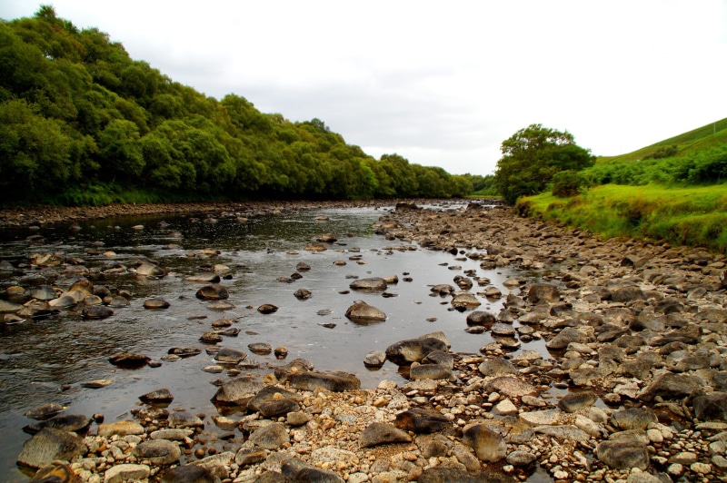 tranquil scene, cloud - sky, rock, watercourse, sky, pebble, rock - object, boulders, highlands and islands, beauty in nature, lonely, tree, flowing water