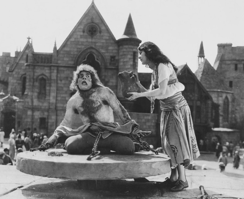built structure, hunchback of notre dame, cinema, vintage, people, representation, ape, film, hollywood, building exterior, mammal, sitting, motion pictures