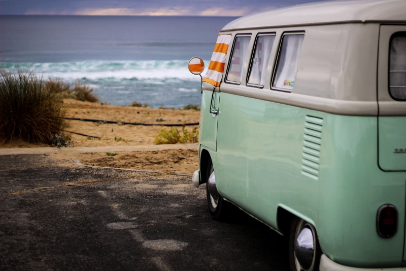 beach, mode of transportation, landscape, vista, public transportation, travel, sea, land, window, van, motion, horizon, minibus, land vehicle, ocean, white