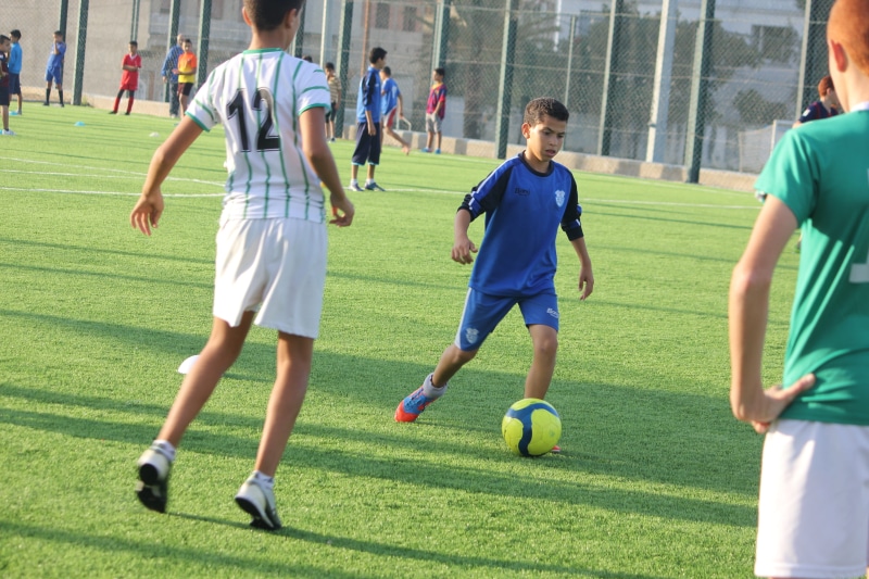 athlete, people, young, football, ball, soccer team, person, champion, soccer, player, activity, men, football player, leisure activity, green color, playing