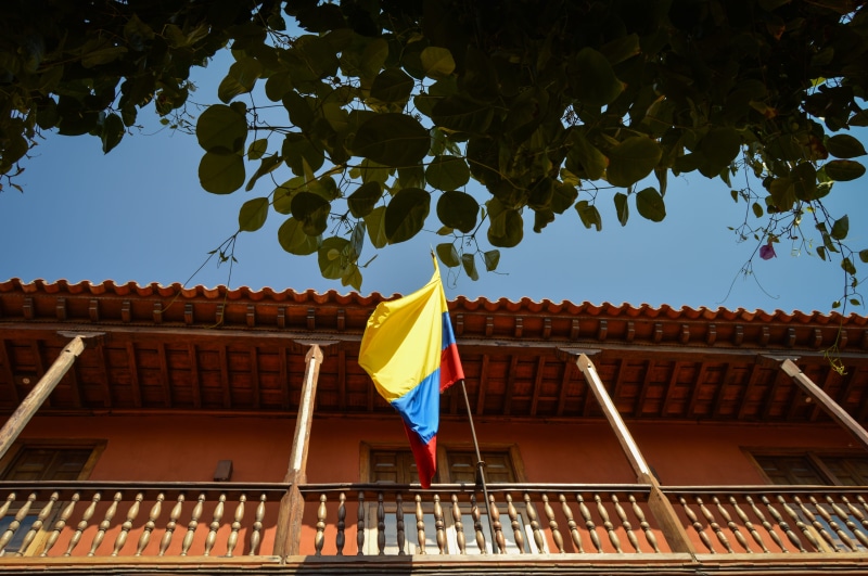architecture, flag, low angle view, no people, 5K, day, belief, roof, tree, wind, america, built structure, colombian flag, outdoors, railing, sky, colombia