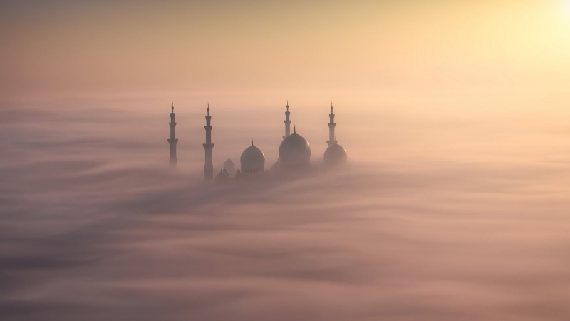 fog, sunset, building exterior, built structure, belief, nature, mosque, mist, daytime, orange color, environment, cloud - sky, spirituality, no people