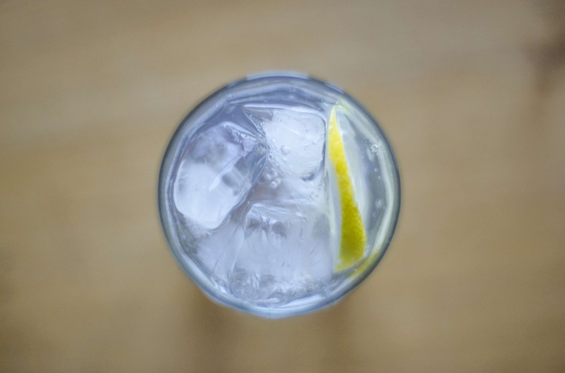 household equipment, drinking glass, glass, single object, table, studio shot, refreshment, indoors, atop, from above, drink, lemon, 4K, ice cube, food and drink