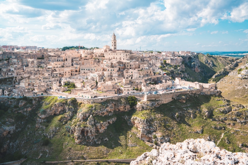 atop, beauty in nature, no people, rock - object, nature, rock formation, travel destinations, solid, city, buildings, sky, cloud - sky, architecture, travel
