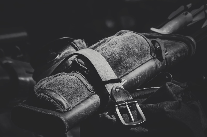 human body part, metal, close-up, war, indoors, 2K, white, army, still life, black, belt, focus on foreground, uniform, grayscale, day, handgun, history