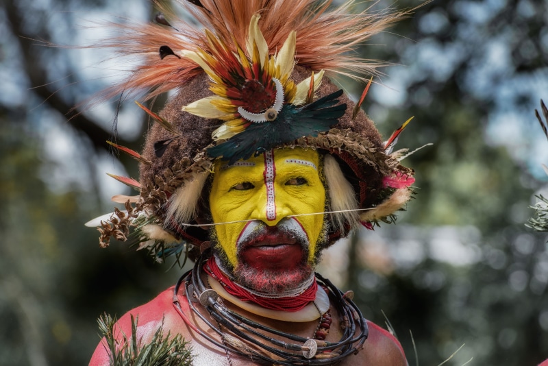 focus, papua new guinea, close-up, female, brown, adult, portrait, performer, focus on foreground, crowd, front view, face, day, head, looking at camera