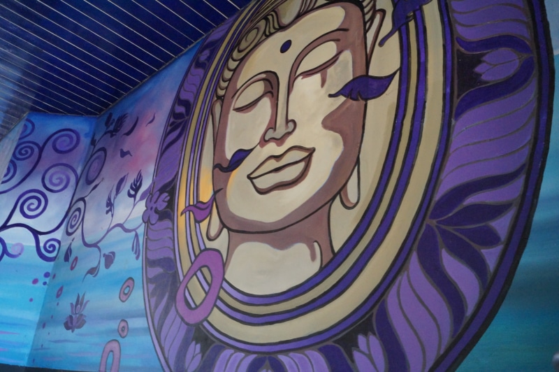 graffiti, human representation, creativity, tapestry, mural, 5K, blue, indoors, art and craft, floral pattern, close-up, built structure, building, Buddha