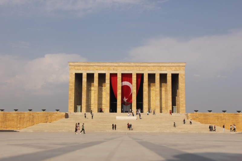 architecture, building exterior, group of people, travel destinations, patriotism, outdoors, turkey, mausoleum, the past, day, red, architectural column
