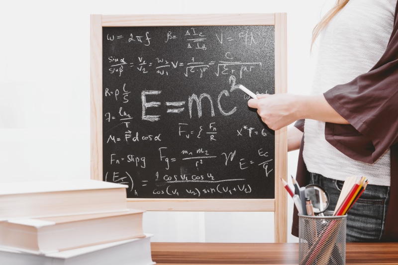 woman, human body part, mathematics, solution, classroom, school, adult, hand, indoors, chalkboard, holding, writing, written, complexity, formula, chalk - art equipment