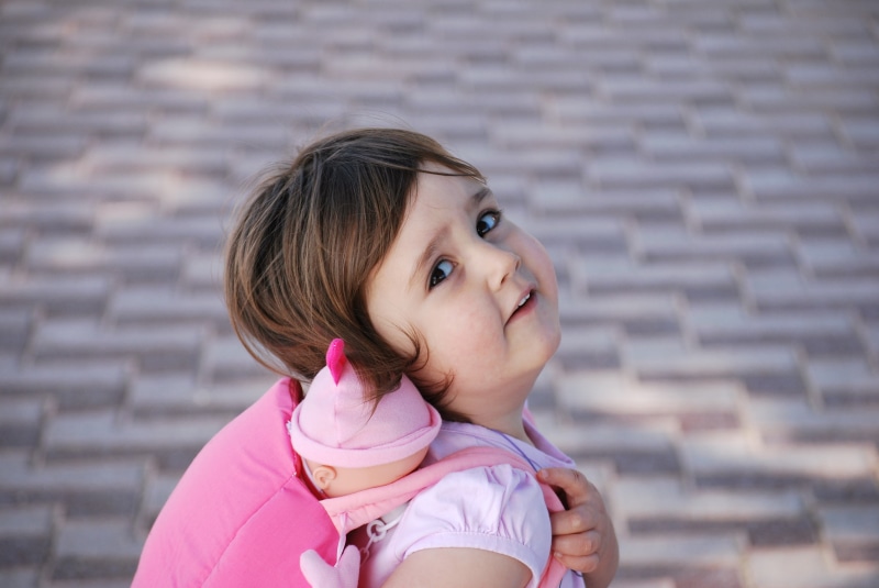 doll, cobbles, mother, pedestrian, brick wall, headshot, childhood, brown hair, women, watching, safe, happy, nurture, 4K, looking at camera, wall, father