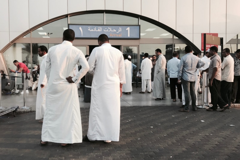 white color, architecture, walking, middle east, makkah region, outdoors, clothing, standing, lifestyles, adult, men, built structure, large group of people