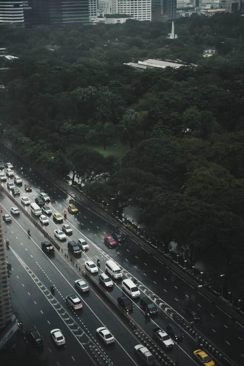 outdoors, land vehicle, symbol, transportation, car, rain drop, marking, roadway, street, city, no people, road, building, plant, built structure, cit life