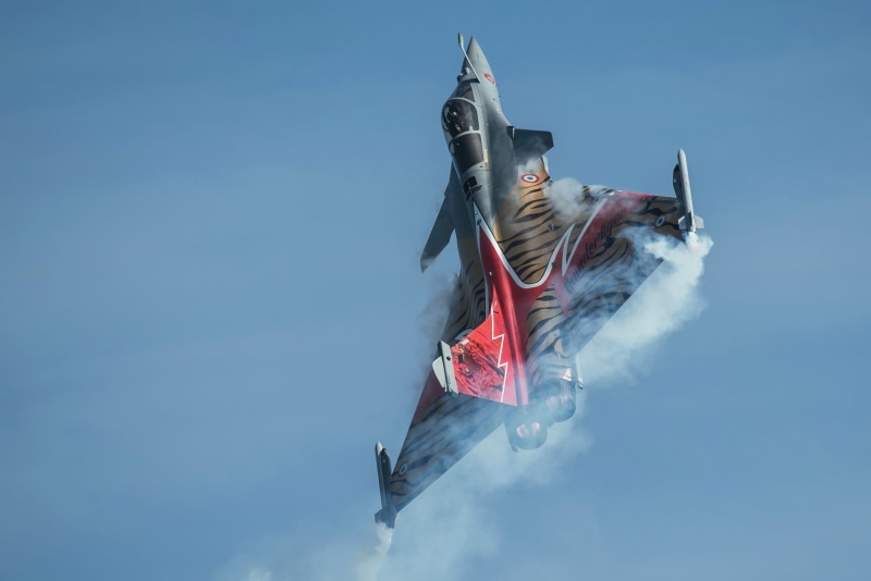 sky, blue, low angle view, emotion, air 14, pride, sport, outdoors, trick, plane, gray, motion, environment, mid-Air, no people, nature, independence, one Person