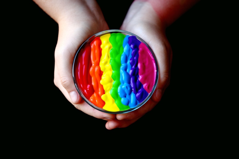 gender, human hand, lesbian, close-up, multi colored, Gay Pride, LGBTQIA, candy, black background, round, lgbt, hand, background, container, multicolor