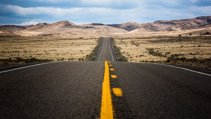 double yellow line, cloud - sky, mountain, sky, diminishing perspective, transportation, landscape, the way forward, arid climate, concrete, mountain range