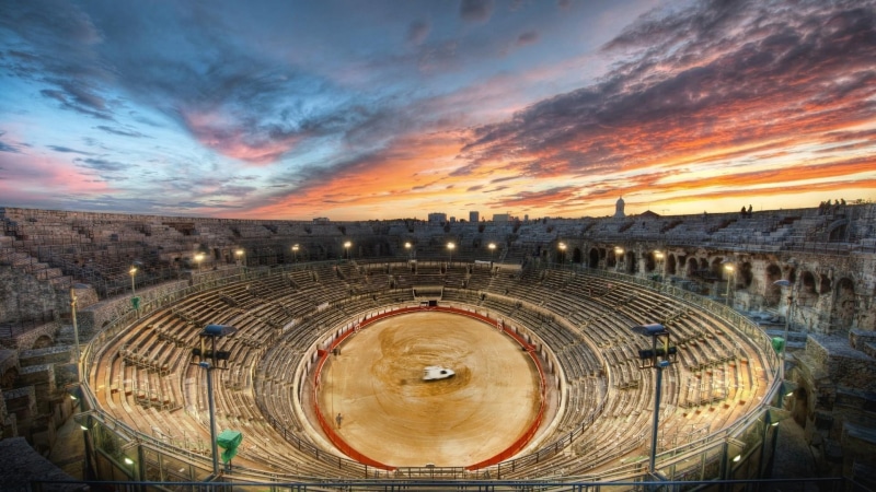 outdoors, sky, travel destinations, amphitheatre, arena, empty, stadium, cloud - sky, built structure, wood - material, dusk, ancient, architecture, orange color