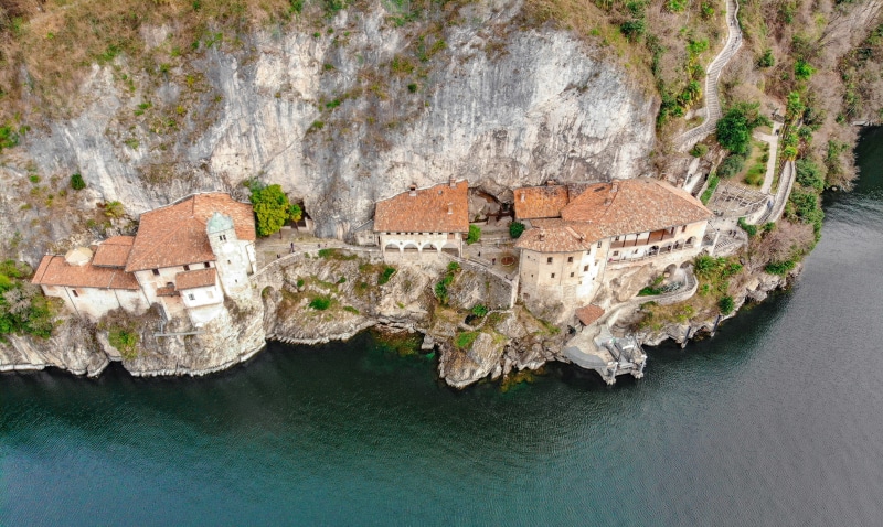canal, catholic, christianity, building exterior, waterfront, solid, architecture, staircase, day, romanesque architecture, aerial view, rock - object