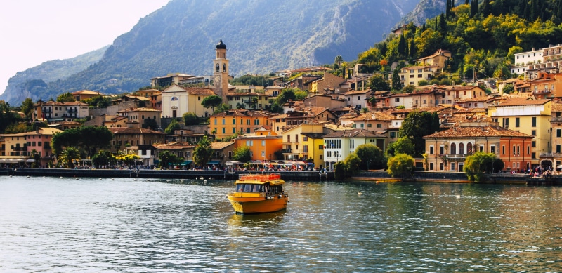 boat, city, place of worship, architecture, residential district, italian, lake, water, town view, garda, travel destinations, homes, mountain range, cityscape