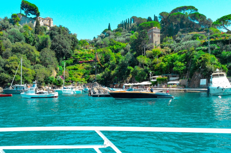 portofino, sky, incidental people, italy, yacht, beauty in nature, green color, water, plant, sunlight, moored, waterfront, tree, the ligurian sea, boats