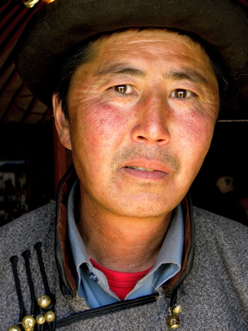 one person, traditional dress, close-up, clothing, looking at camera, nomadic, social issues, gobi desert, males, mature adult, contemplation, human face