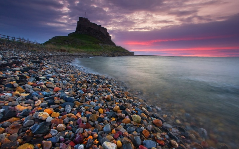 surface level, history, tranquility, solid, sky, castle, tranquil scene, sea, ancient, clouds, England, beach, land, cloud - sky, horizon over water, stone