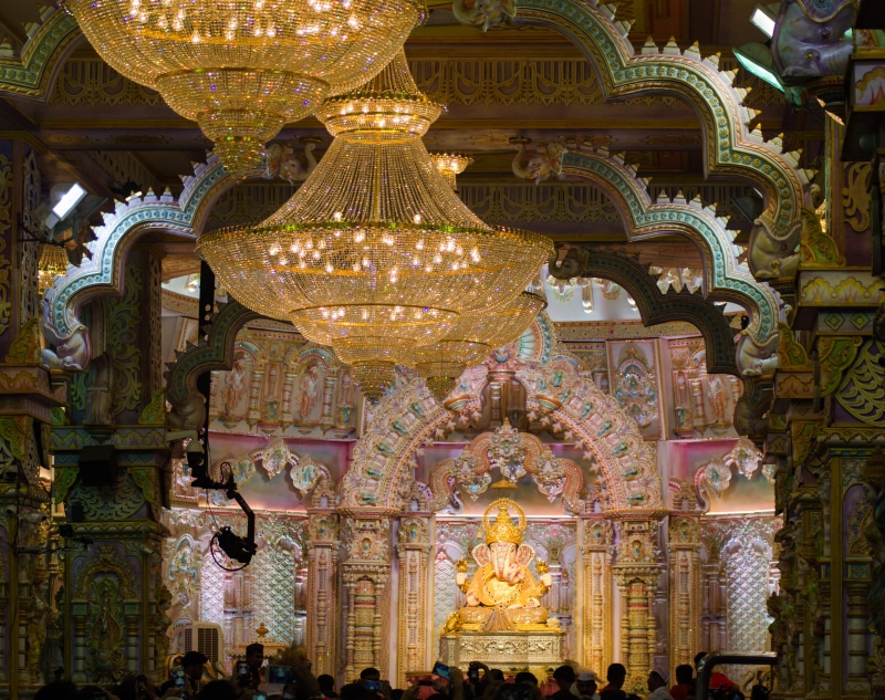 gold colored, place of worship, chandelier, religion, architectural column, lighting equipment, throne, representation, building, building exterior, human representation