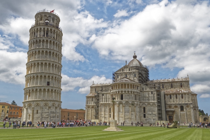 architecture, cloud - sky, church, built structure, architectural column, large group of people, the past, memorial, history, monument, grass, outdoors
