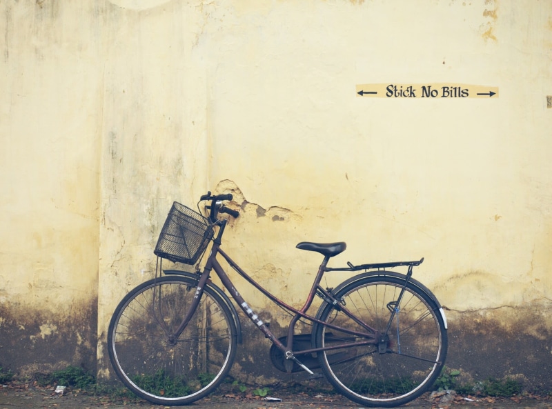 land vehicle, bicycle, architecture, culture, outdoors, tourism, building exterior, india, kerala, sepia, wall - building feature, text, no people, communication