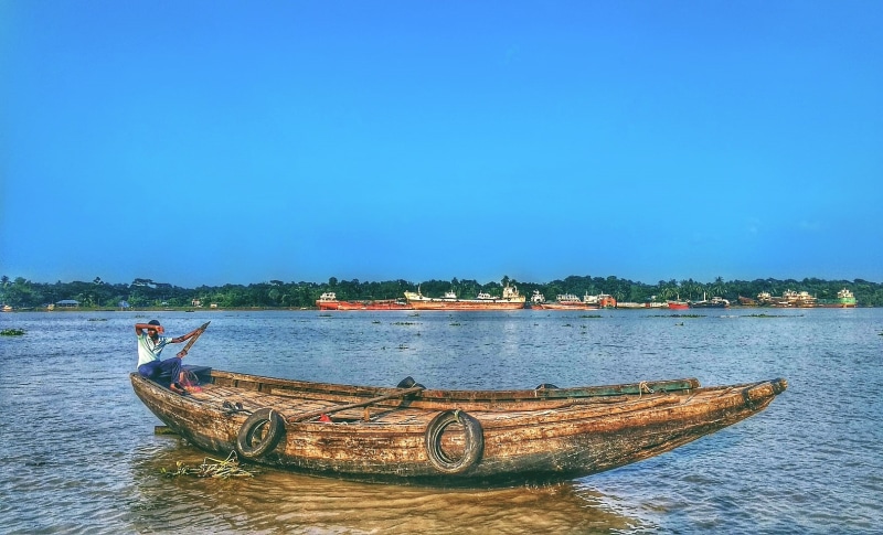 nautical vessel, blue, men, fishing boat, boat, river, transportation, river delta, nature, mode of transportation, day, sky, clear sky, Bangladesh, tree