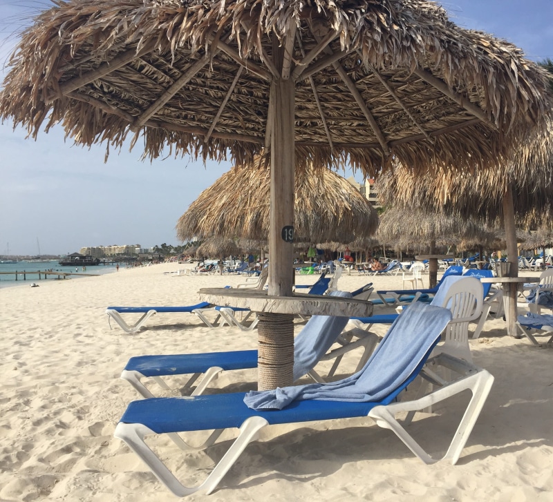aruba, thatched roof, vacation, sand, day, shade, no people, palapa, tranquility, beach umbrella, beauty in nature, sea, outdoors, beach, roof, water, 2K