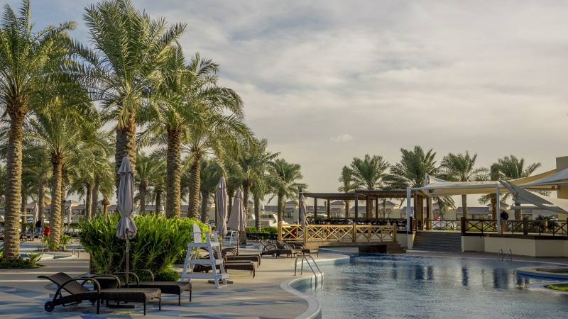 plant, architecture, tree, resort, pool, hotel, outdoors, leisure, no people, chair, sunbed, sky, cloud - sky, water, travel destinations, bahrain, vacation