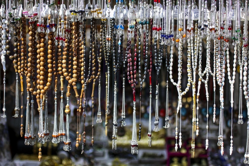 arrangement, for sale, glass - material, prayer, abundance, food, no people, food and drink, indoors, silver rosary, selective focus, islam, water, choice