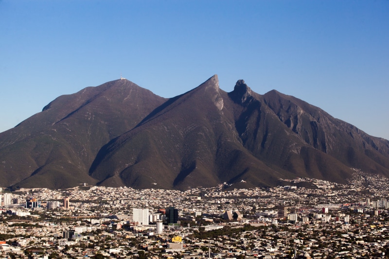 outdoors, residential district, building, sunlight, mountain range, built structure, cityscape, architecture, copy space, townscape, nature, mountain, landscape