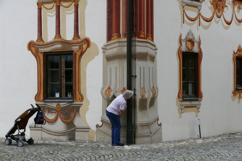 art form, trompe-lœil, one person, slip painting, building exterior, building, rear view, baby carriage, woman, buggy, austrian, adult, street, leisure activity