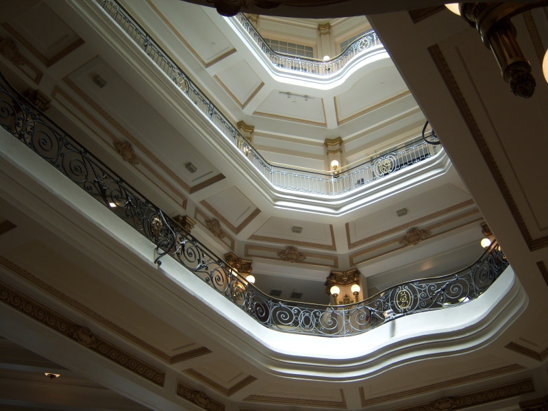 low angle view, architecture and art, built structure, wealth, design, chandelier, light, architectural feature, building, indoors, skylight, illuminated