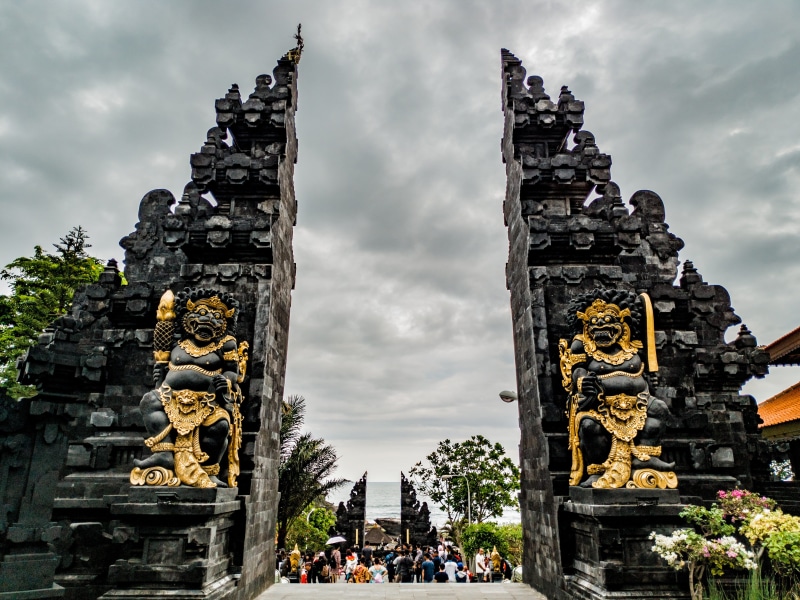 sculpture, entrance, ancient, water, history, outdoors, ornate, cloud - sky, architecture, ancient civilization, tanah lot, spirituality, place of worship