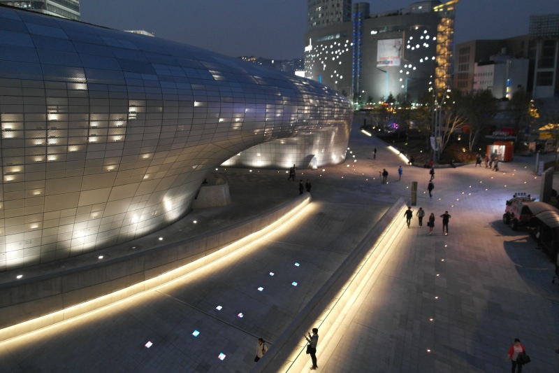 built structure, road, walk, urban Scene, night view, car, 5K, people, high angle view, outdoors, incidental people, near, nightlife, street, dongdaemun design plaza